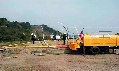 A trailer concrete pump machine is working.